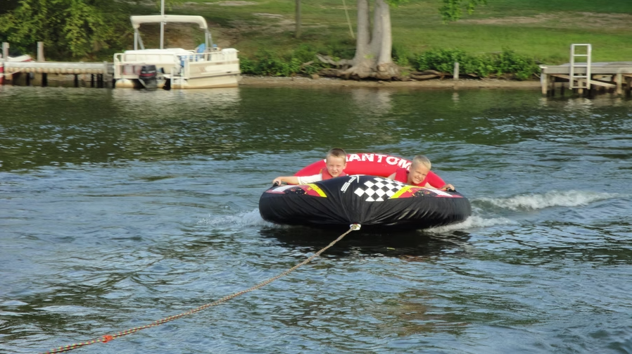 Our sons when young tubing on the water